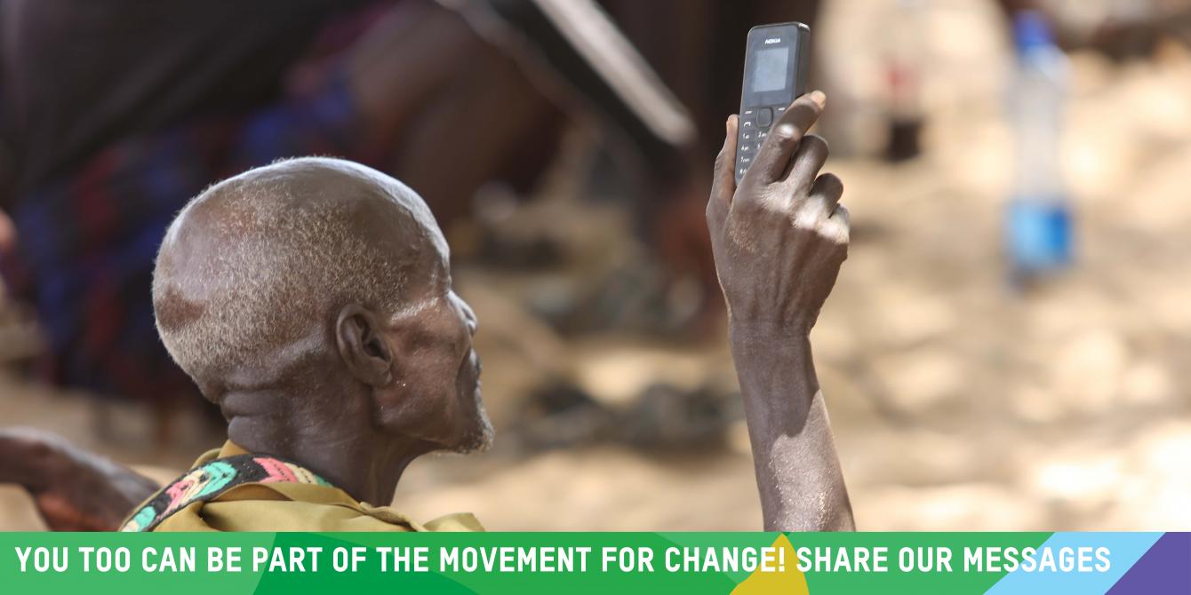 Turkana man holds out his mobile phone during a public baraza on oil and community rights in Lokichar, Turkana. Photo Credit: LightBox Limited Turkana man holds out his mobile phone during a public baraza on oil and community rights in Lokichar, Turkana. Photo Credit: LightBox Limited